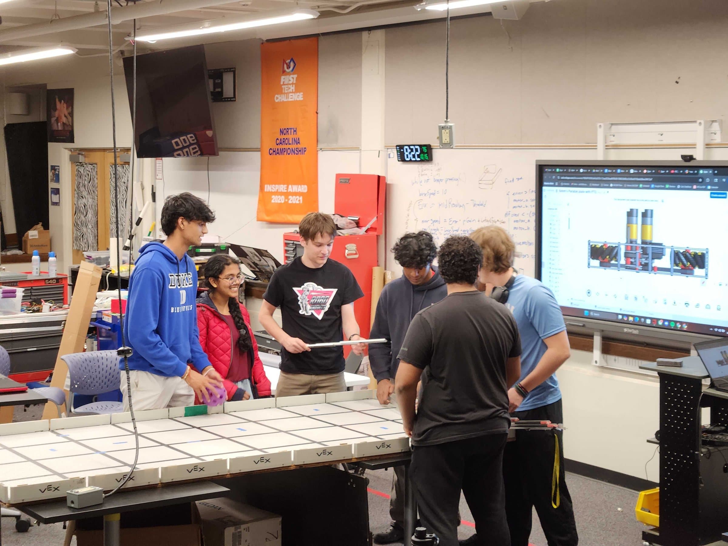 The RoboKnights working together in their robotics lab